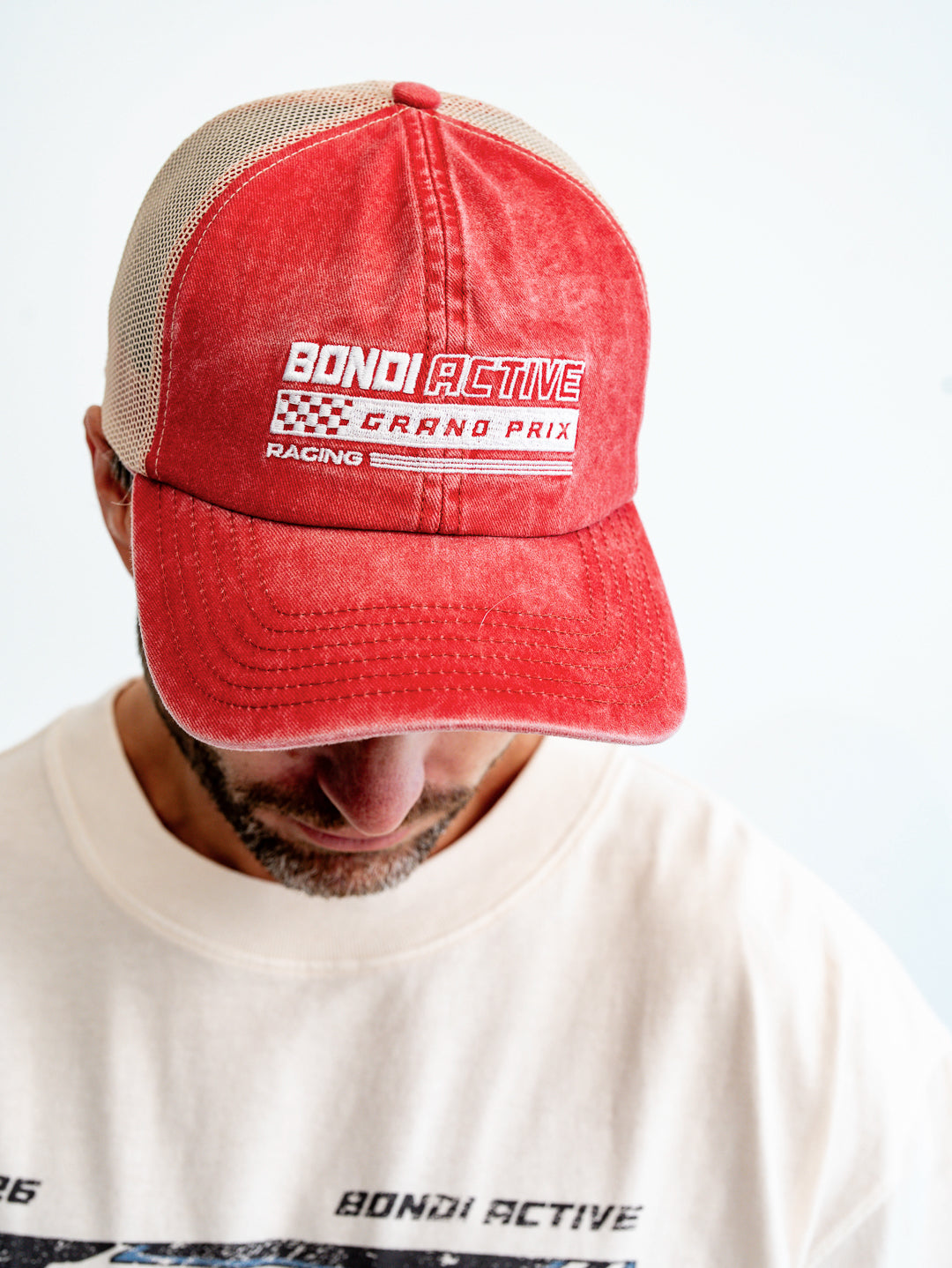 Close-up of washed red and white cap on model