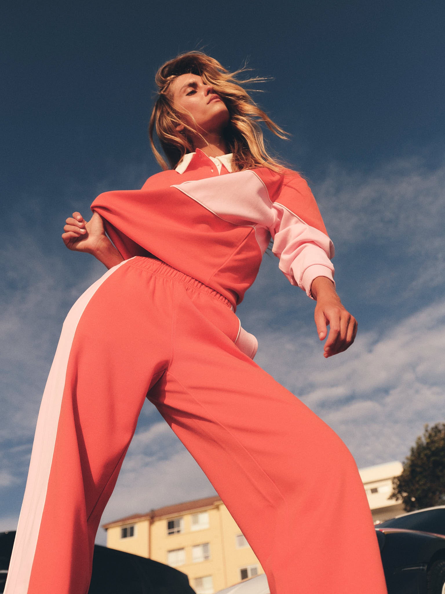 Model wearing tomato red and pink wide leg pant