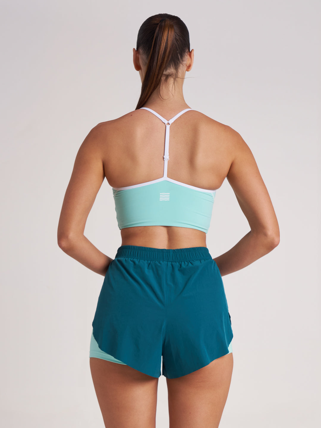 Back view of mint green sports bra crop