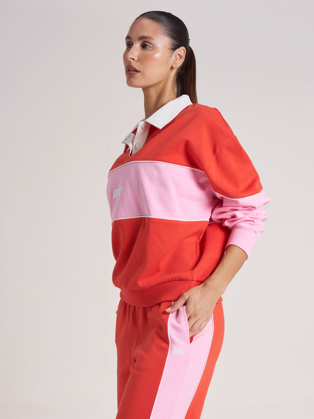 Side profile of tomato red and pink wide leg pant on model