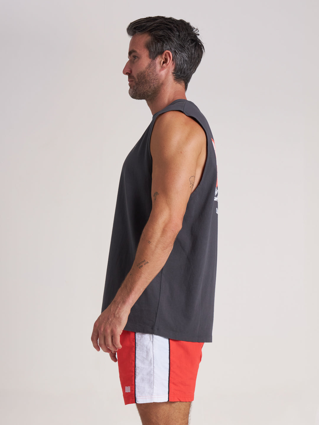 Side profile of charcoal grey and red tank top