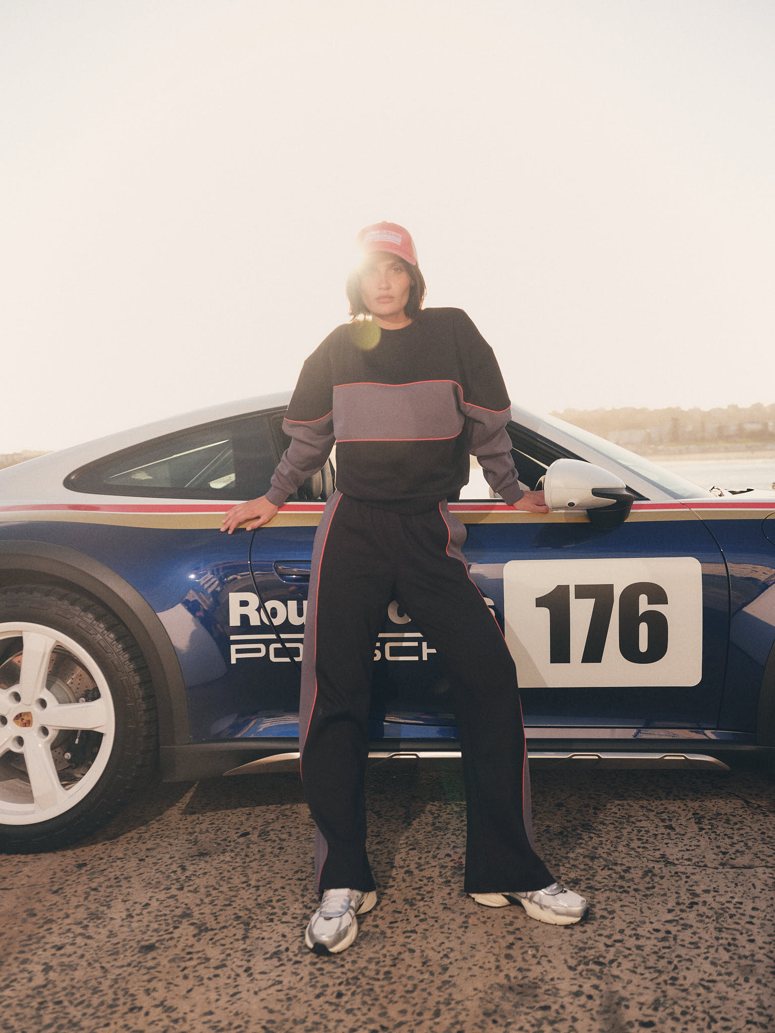 Model in motion wearing black and grey sweatshirt and matching wide leg pant